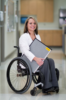Woman in wheelchair working in hospital