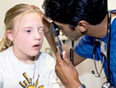 A girl receives an eye exam